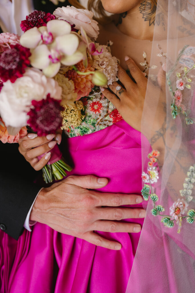 gorgeous, colorful, hand details on wedding gown and veil